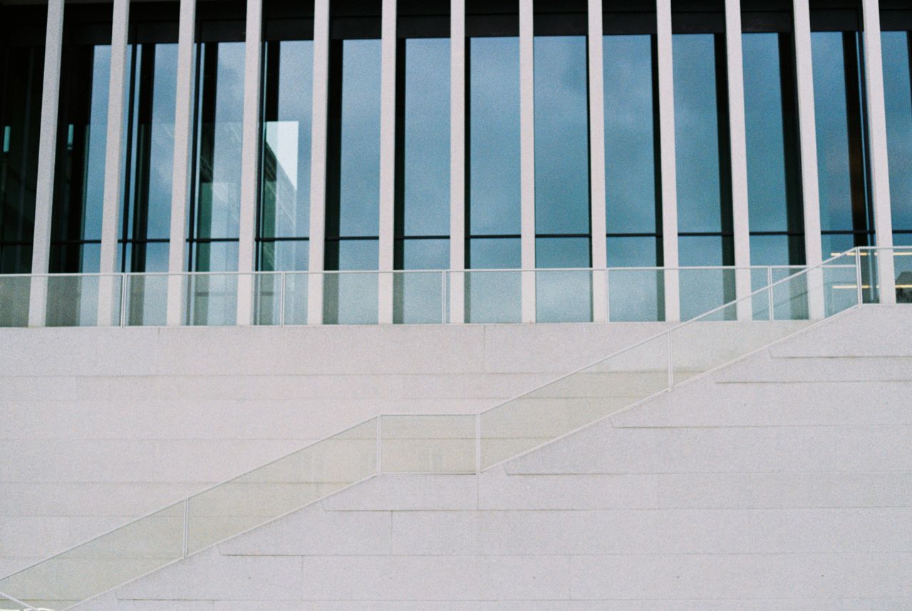 symmetrical view of a modern building s glass fa ade with minimalistic