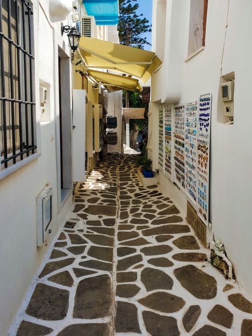 Free Explore a picturesque narrow alley with traditional Greek stonework in Paros, Greece. Stock Photo