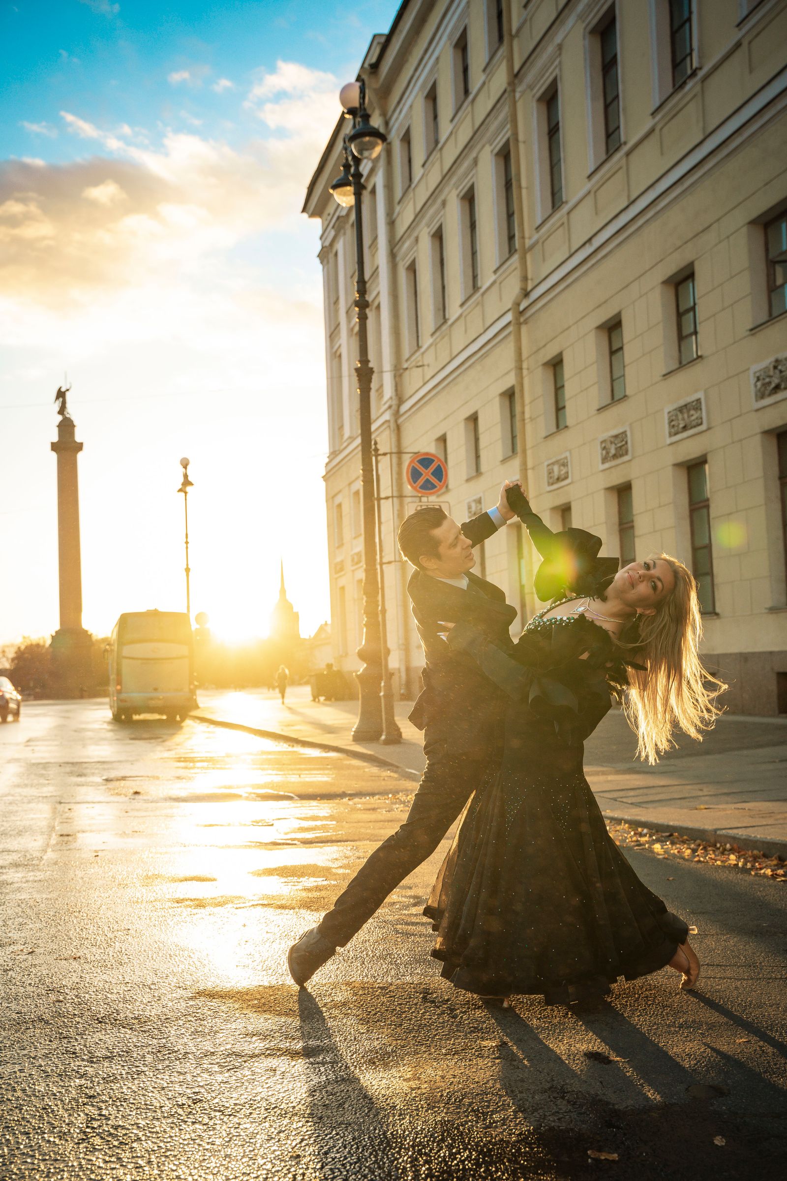 Foxtrot — elegant couple dancing gracefully on a city street at golden sunset. Stock photo.
