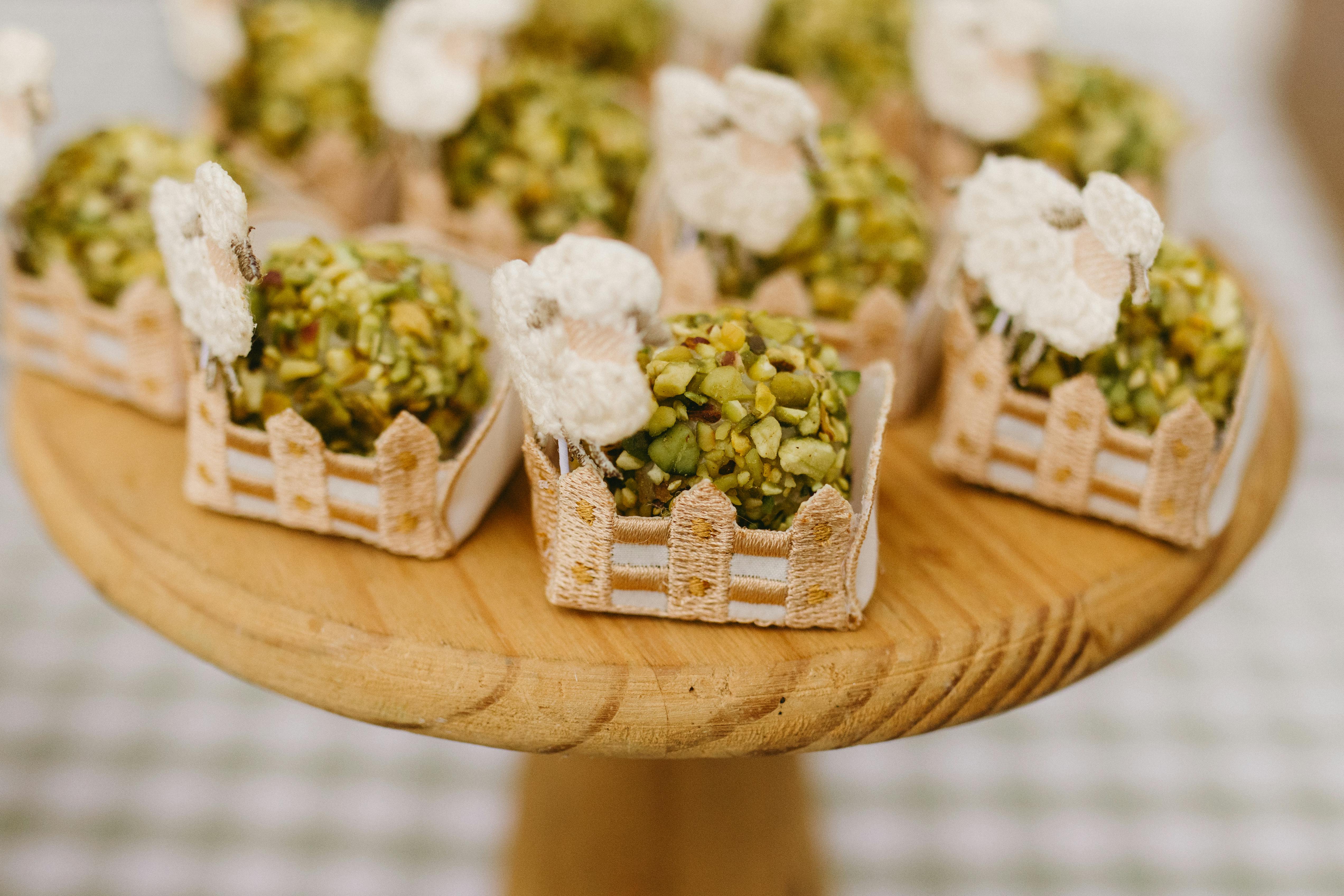 Delightful pistachio confections arranged on a wooden stand, perfect for celebrations.