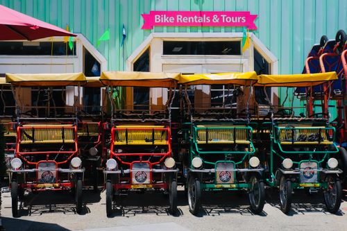 Free Bright rental bikes ready for tours outside a rental shop. Stock Photo