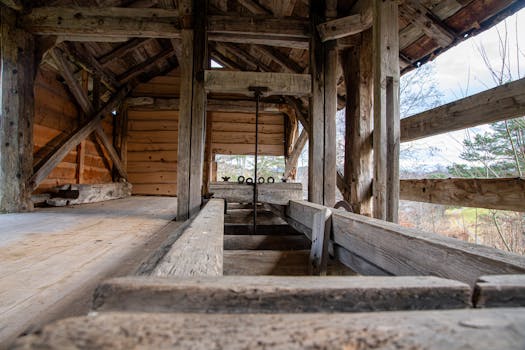 Photo by Andreas Berget A detailed view of a rustic wooden sawmill structure in Norway, showcasing traditional craftsmanship.