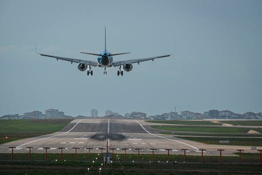 A commercial airplane approaches a runway for landing at Istanbul's airport, showcasing aviation precision.