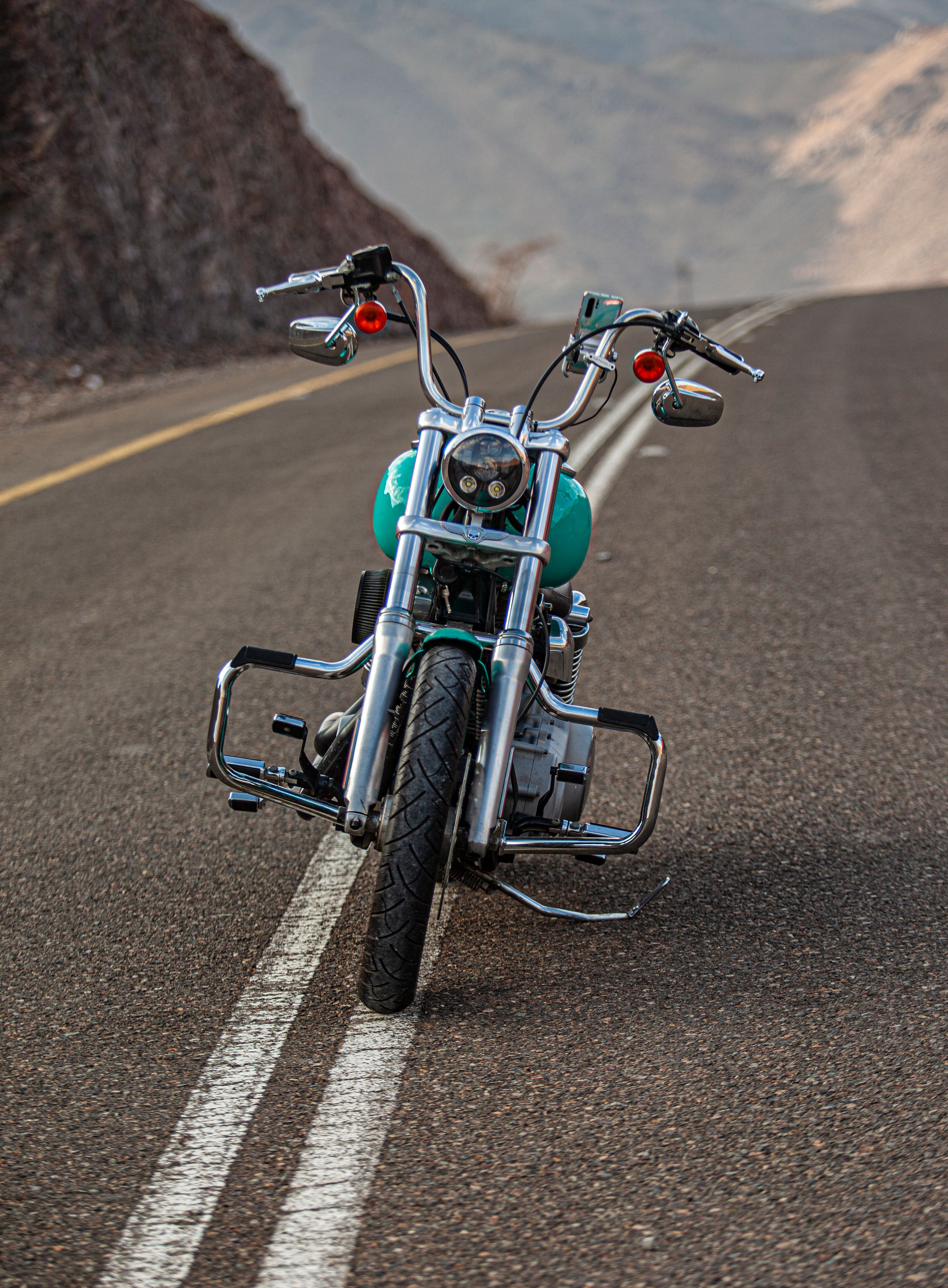 Rider on Motorcycle Facing Majestic Mountain · Free Stock Photo