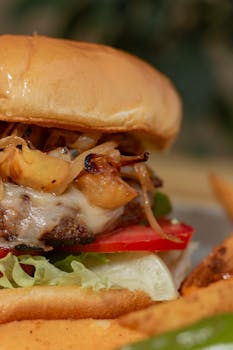Close-up shot of a delicious gourmet burger with grilled onions and toppings.