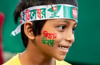 Cheerful child with face paint celebrating Bangladesh Victory Day.