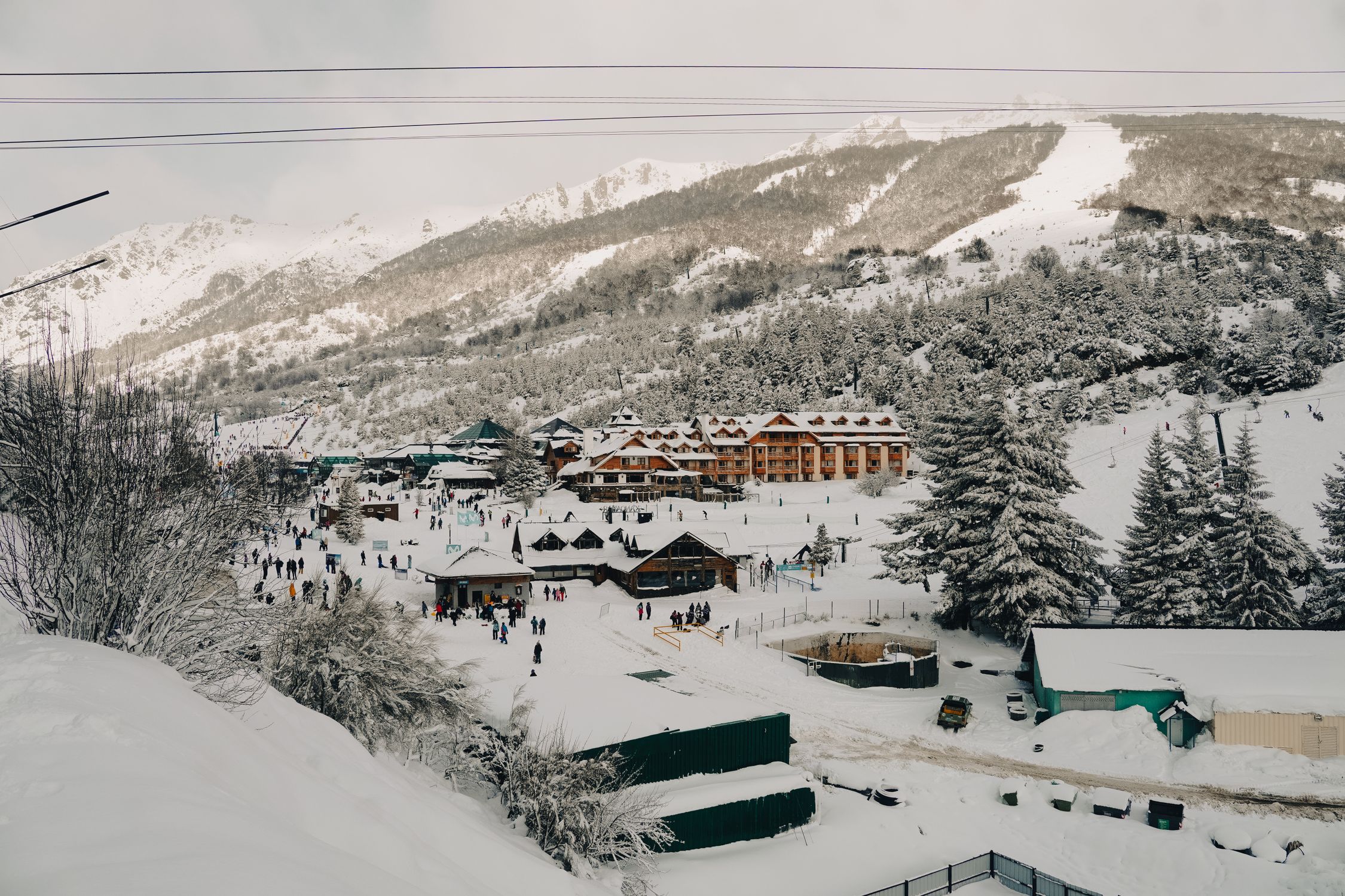 Panoramic view of a snowy ski resort in Bariloche, Argentina, during winter.