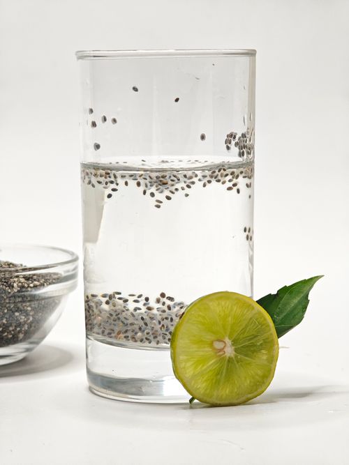 Free Glass of chia-infused water with lime slice, perfect for hydration and health. Stock Photo