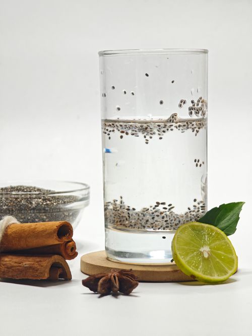 Free Glass of chia seed water with lime, star anise, and cinnamon sticks for a refreshing and flavorful drink. Stock Photo