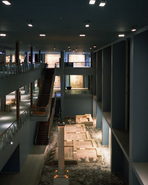 Free Spacious museum interior showcasing ancient artifacts under ambient lighting. Stock Photo