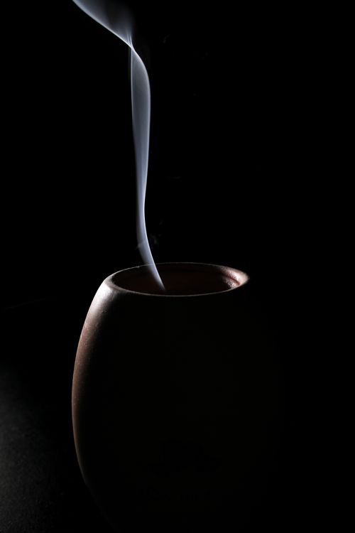 Dark clay vessel with rising steam — Senna Doe on Pexels
