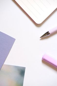 A minimalist workspace flat lay with pastel stationery and a blank notebook.
