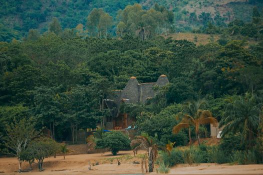 A picturesque thatched-roof villa hidden in dense jungle, offering a serene tropical escape.