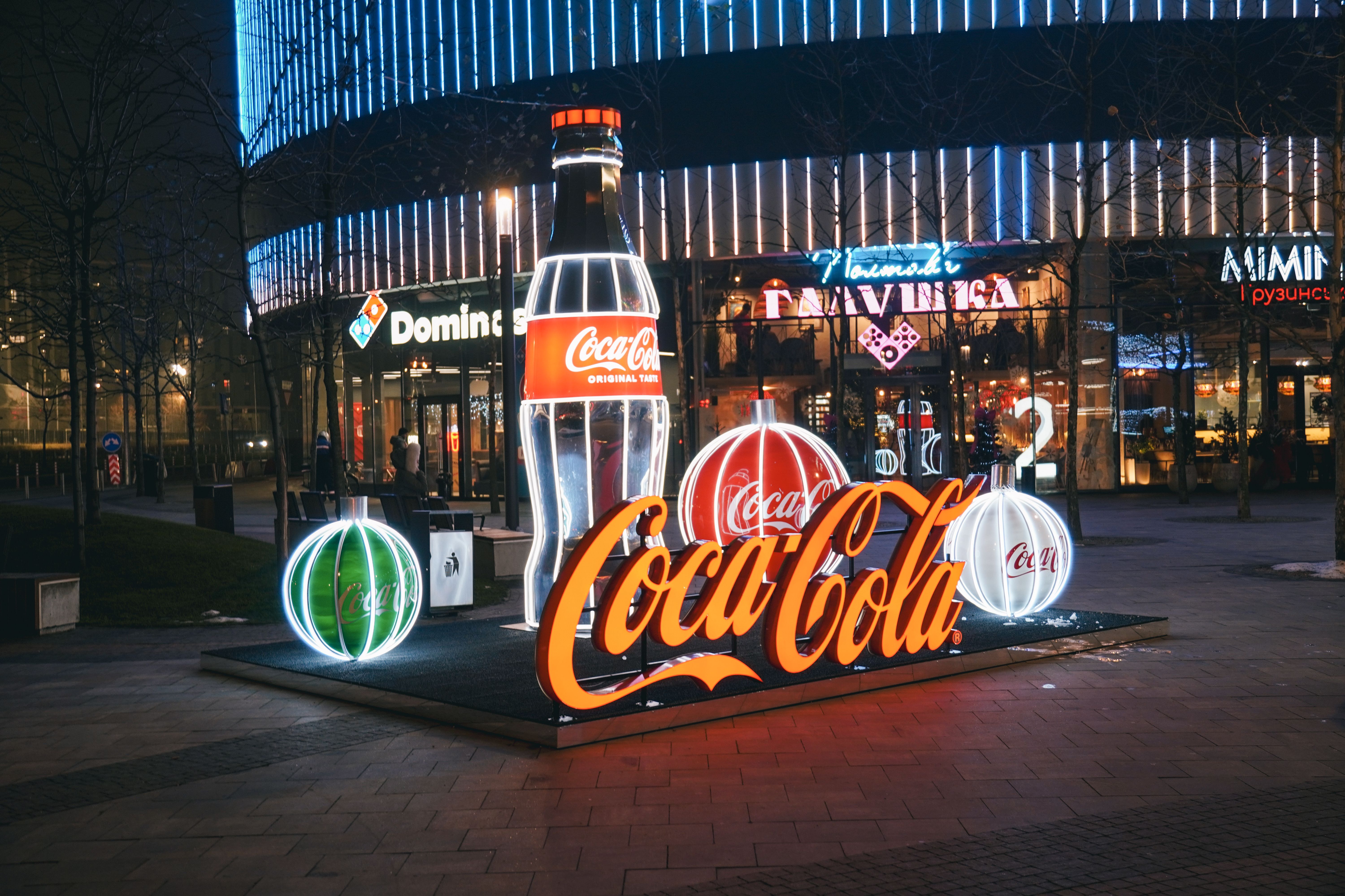 Illuminated Coca-Cola display at night in Kyiv, showcasing vibrant city nightlife.