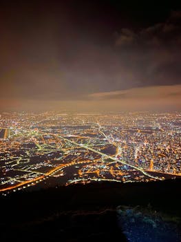 A breathtaking aerial view of city lights sprawling across the horizon at night.