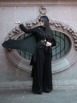 Elegant woman in black fashion standing outdoors in Mexico City, exuding modern elegance and style.