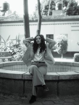 Stylish black and white portrait of a fashion model sitting outdoors in Condesa, Mexico City.