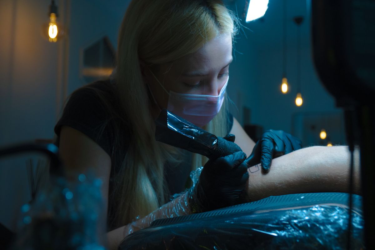 Tattoo artist working in the studio