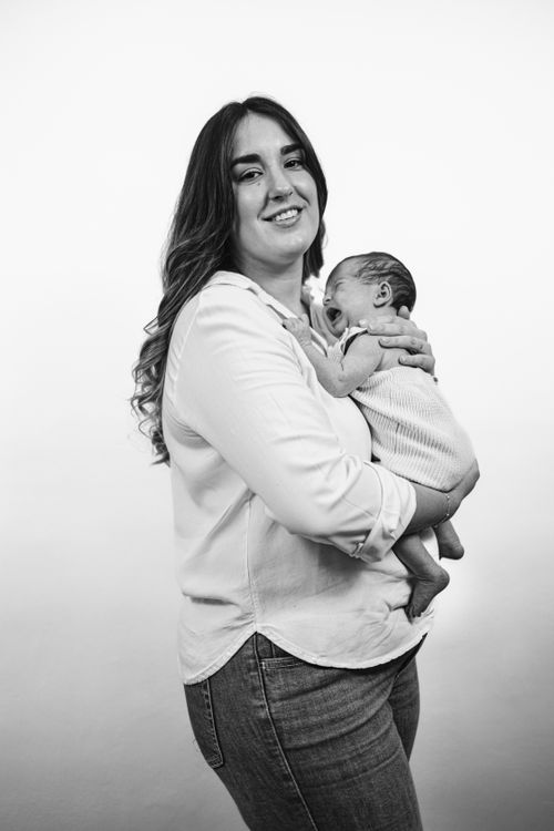 Free Charming black and white portrait of a mother lovingly holding her baby. Stock Photo