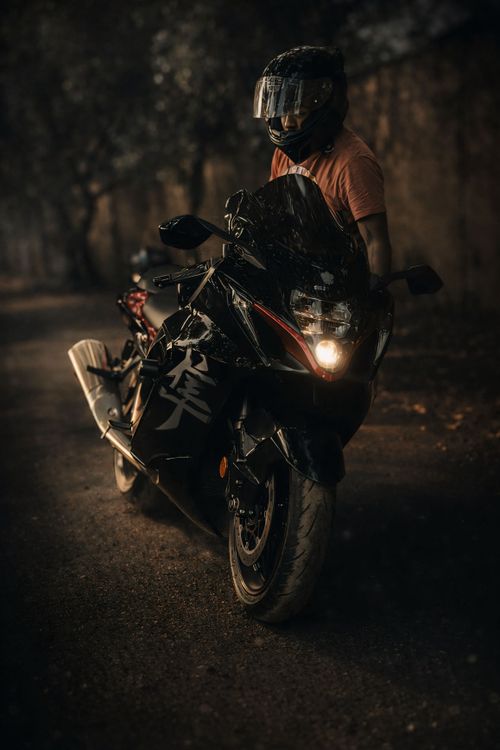 Free A rider on a sleek black sport motorcycle at night, exuding adventure. Stock Photo