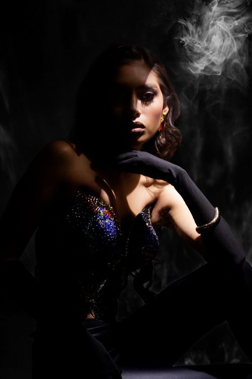 Free Elegant woman in dark lighting with smoke, showcasing glamour and mystery. Stock Photo
