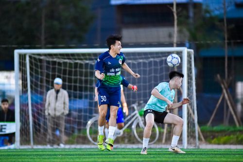 Free Intense action during a football game at an outdoor field in Hà Nội, Vietnam. Stock Photo
