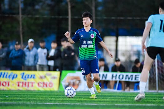 Young soccer player in Hanoi, Vietnam, ready to kick the ball during a match.