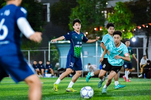 Free Vibrant football match with players in action at a local field in Hanoi, Vietnam. Stock Photo