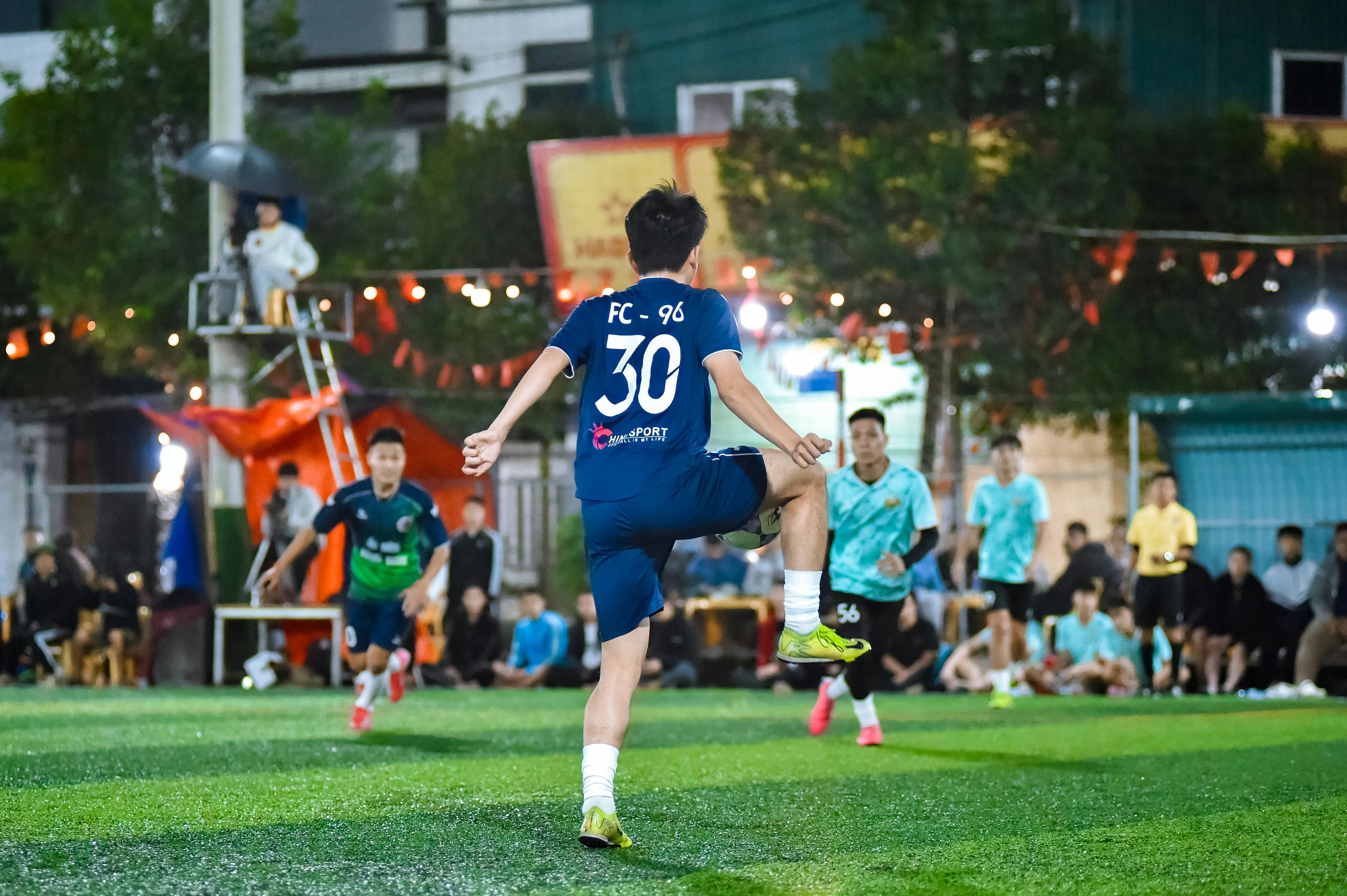 An exhilarating nighttime soccer match captures players in motion on a local field in Hà Nội.