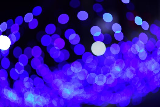 Colorful abstract bokeh lights in blue tones creating a festive and vibrant atmosphere.