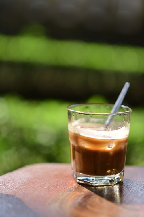 Free A close-up of iced coffee with a straw outdoors, perfect for a summer refreshment. Stock Photo