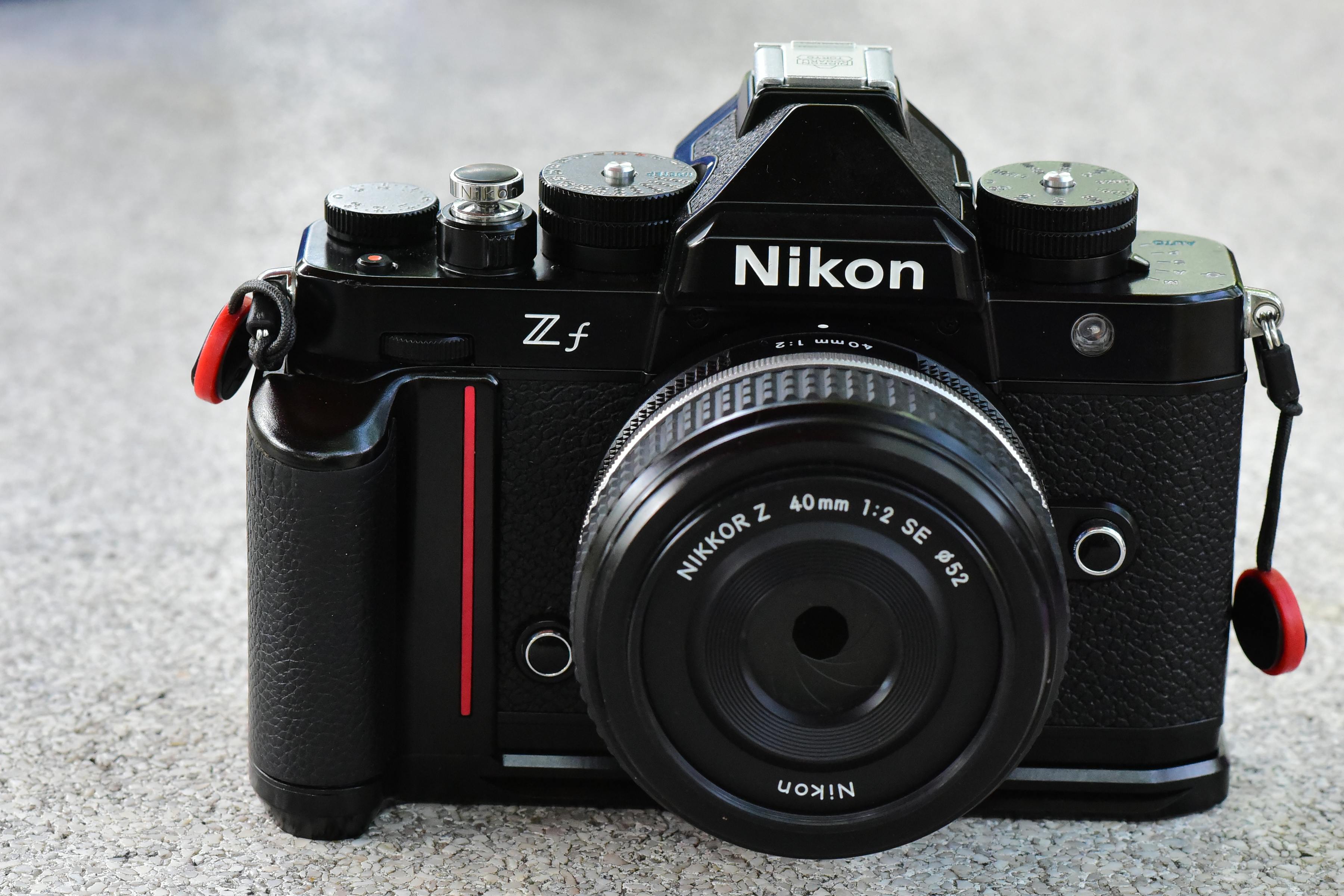 High-quality image of a Nikon Zf mirrorless camera on a textured stone background.