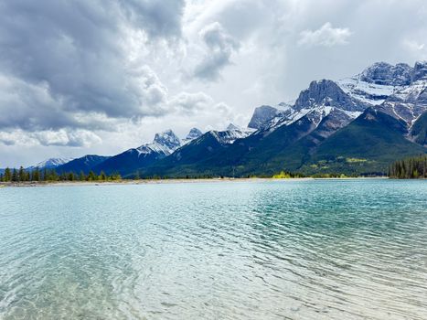 Capture of Banff's stunning landscapes with mountains and lake under dramatic skies.