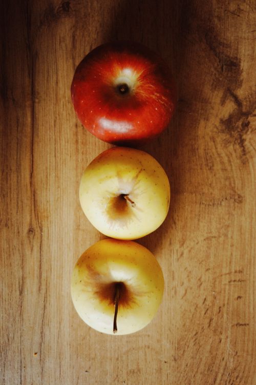 Free Three apples arranged on a wooden surface, showcasing vibrant colors. Stock Photo