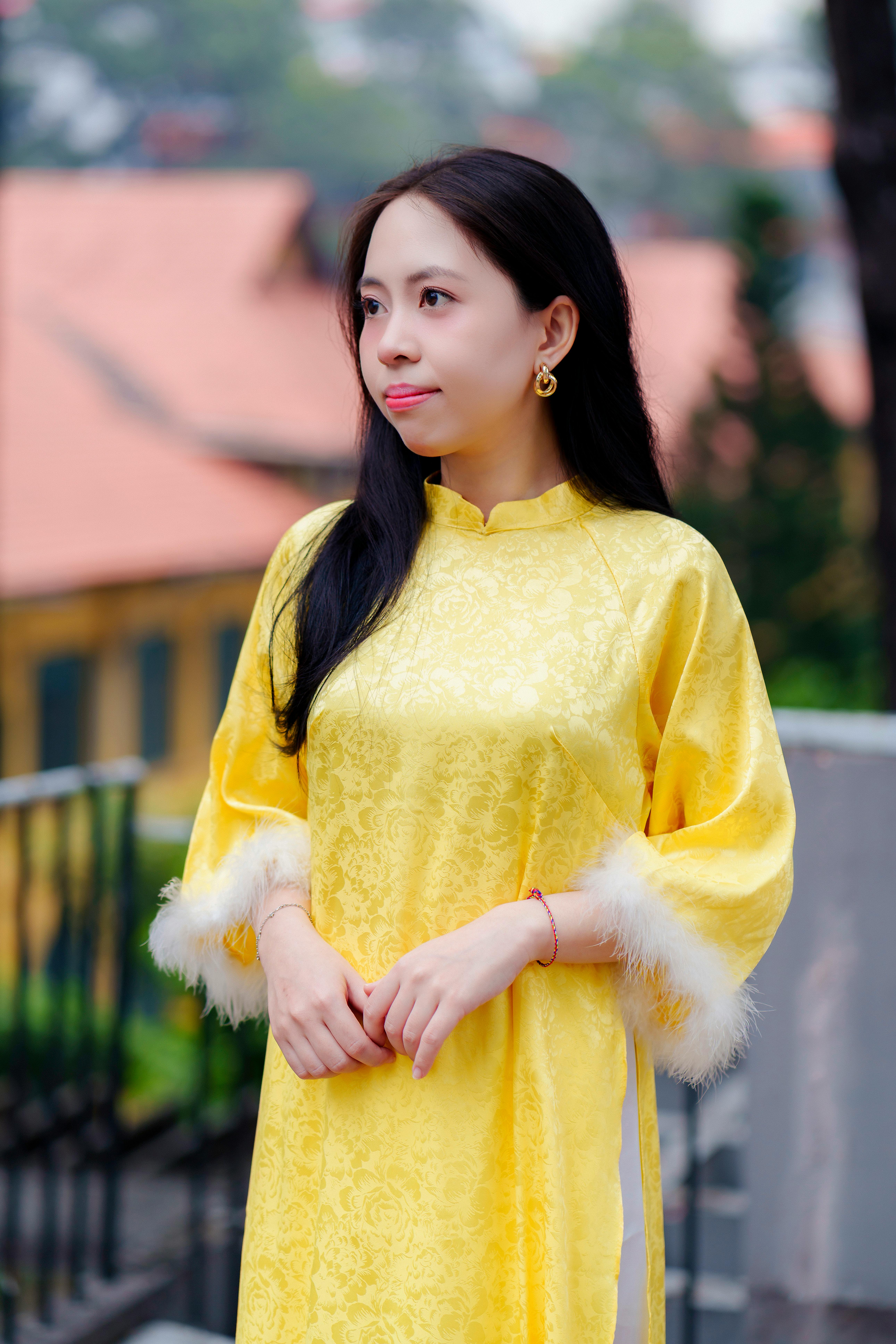Woman wearing traditional Vietnamese áo dài in an outdoor setting in Ho Chi Minh City.