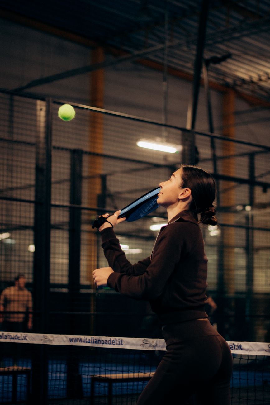 Padel player mid-rally on court