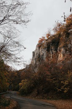 Beautiful autumn landscape featuring a limestone cliff and road in Hungary.