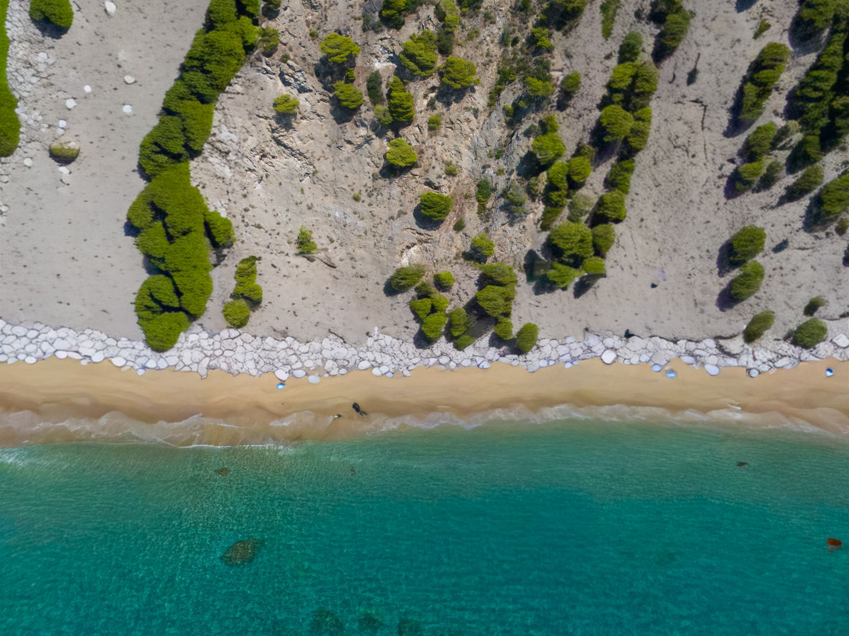 A breathtaking aerial shot of Glyfada Beach in Greece with azure waters and sandy shores.