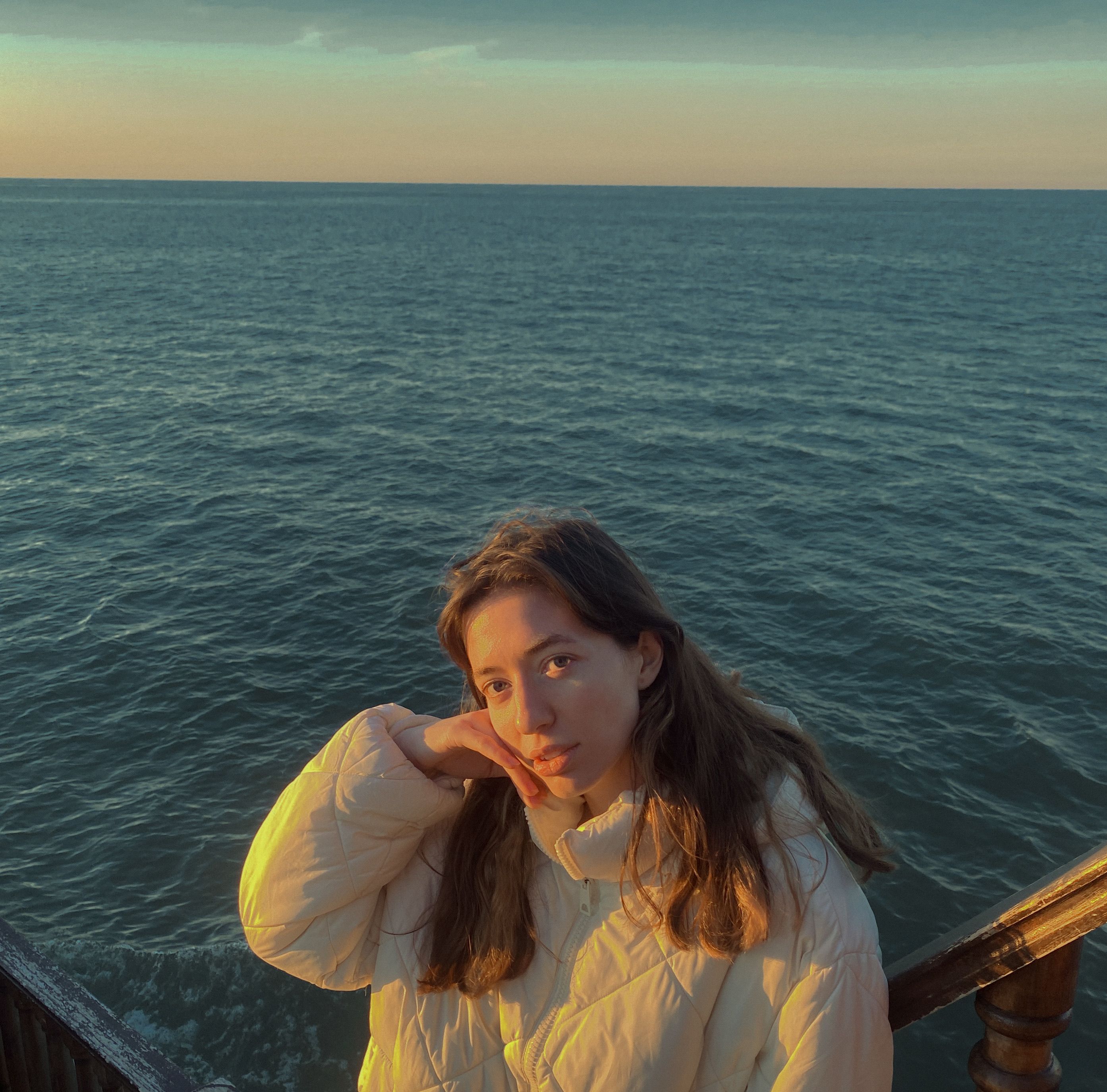 Young Woman Posing on Oceanfront at Sunset · Free Stock Photo
