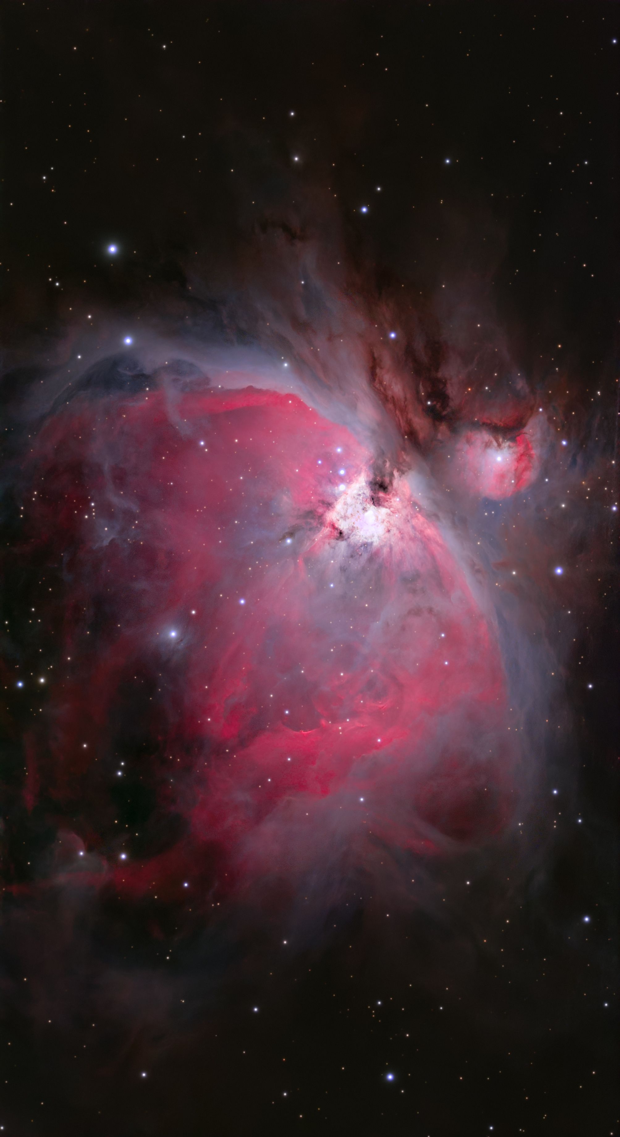 A breathtaking view of the Orion Nebula with vivid reds and cosmic details.
