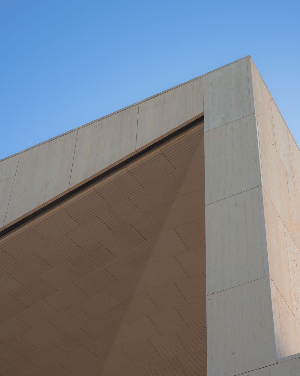 Villa Sera — minimalist white structure against blue sky in Spain