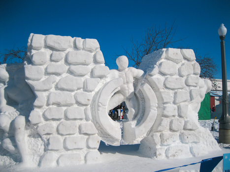 Stunning snow sculpture exhibit in Frankenmuth, Michigan under a clear blue sky.