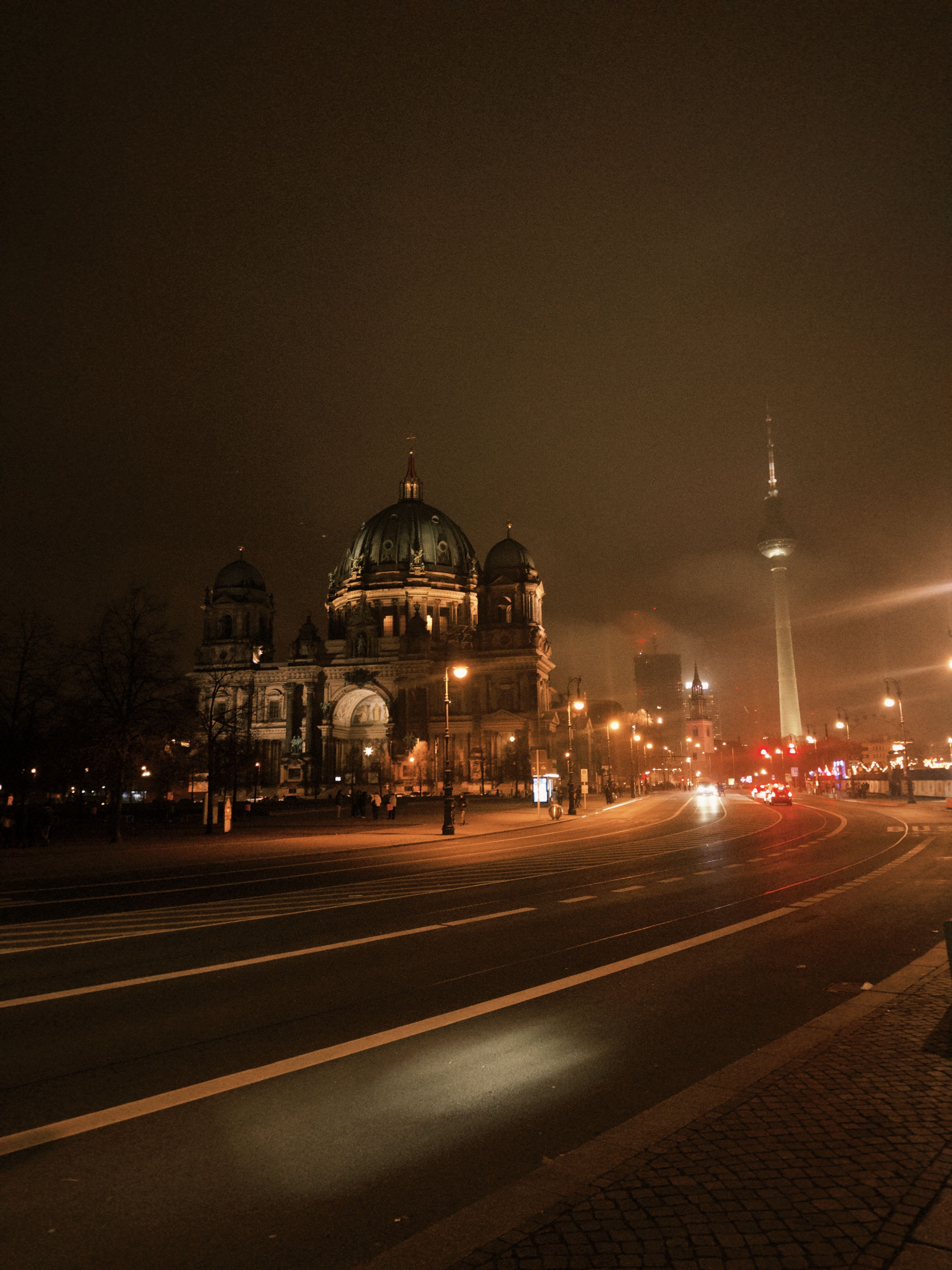 Dramatic nighttime view of Berlin's iconic Cathedral and TV Tower.