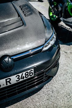 Detailed shot of a car with a carbon fiber hood and license plate. Perfect for automotive enthusiasts.