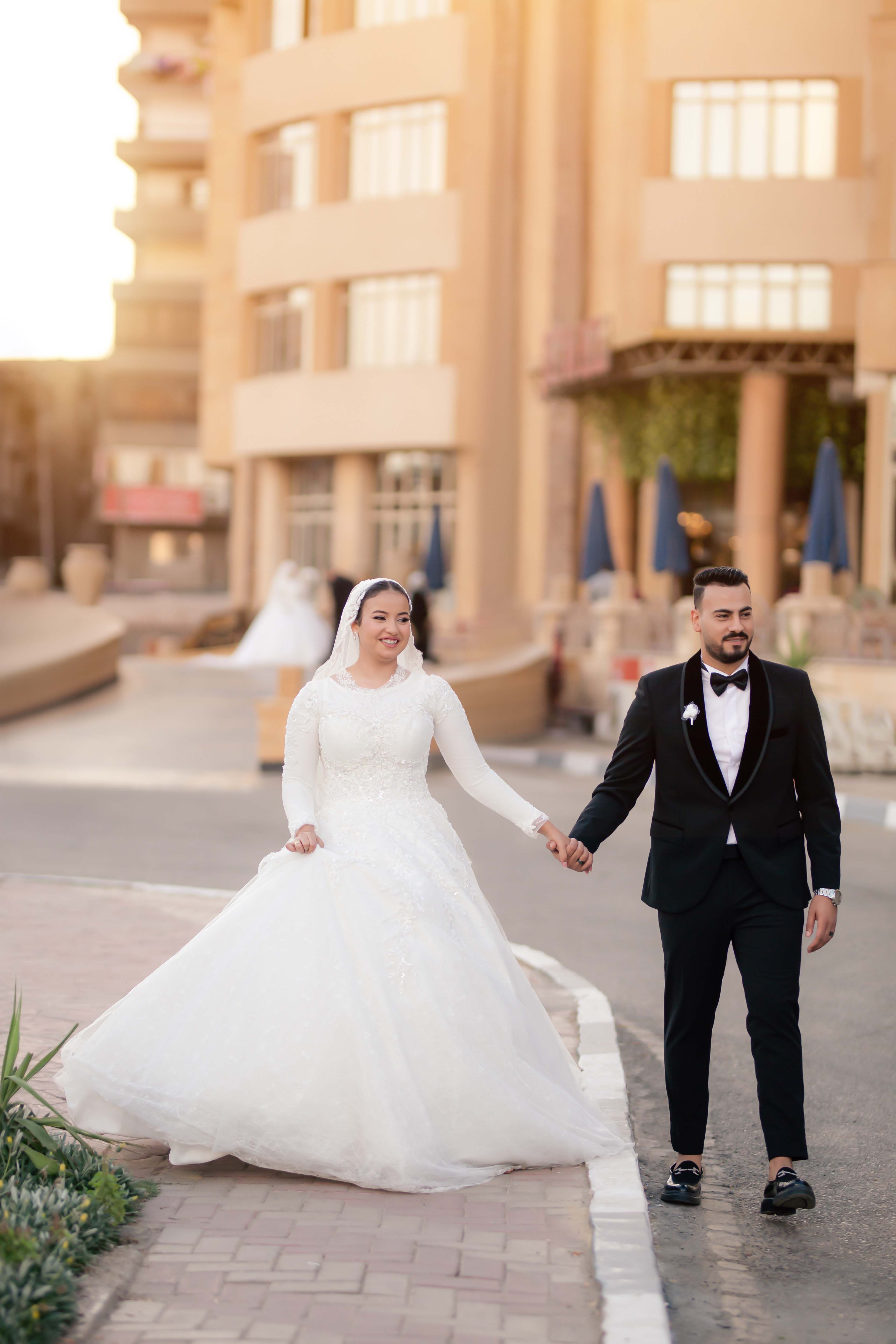 Romantic shot of a couple in wedding attire outdoors.