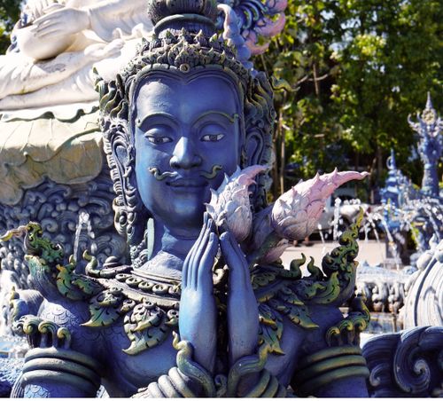 A blue statue with wings and a blue head · Free Stock Photo