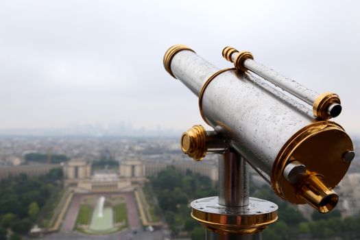 A scenic view of Paris as seen through a telescope on the Eiffel Tower.