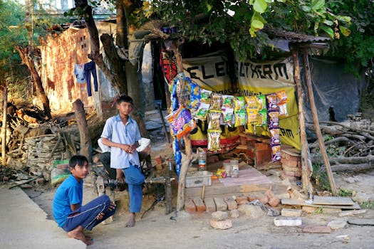 A rustic street food stall with children in Garodiya, Gujarat, captured in natural daylight.