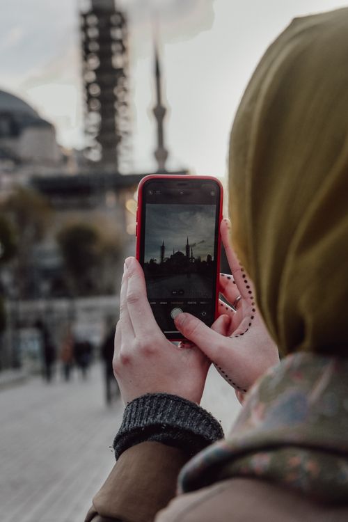 Free A person photographs the iconic Hagia Sophia in Istanbul with a smartphone, capturing its historic beauty. Stock Photo