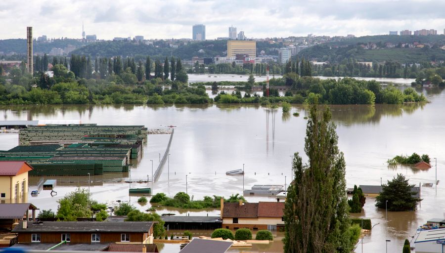 Elevated view of a river town with streets and low buildings under floodwater — photo by Valentin Ivantsov on Pexels